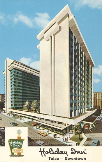A Holiday Inn sign is displayed in front of a large building.